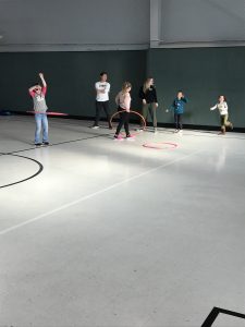 children playing with hula hoops